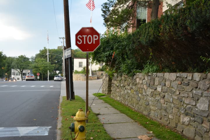 A new stop sign has been added to an intersection by the Bedford Hills firehouse.