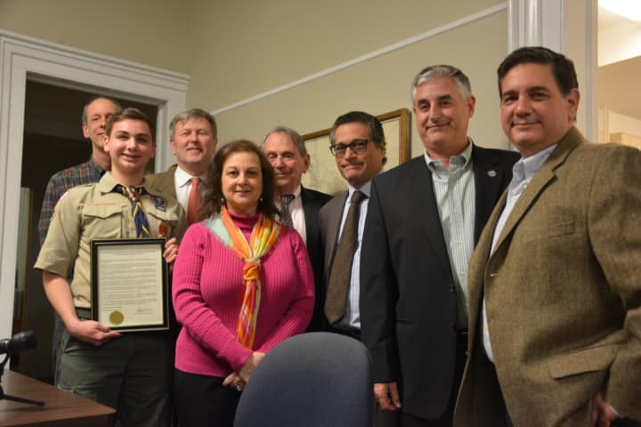 Local Eagle Scout Steven Palmesi (second from left) poses for photos with Lewisboro Town Board members. Also present are parents Lisa (center) and Tony (right).