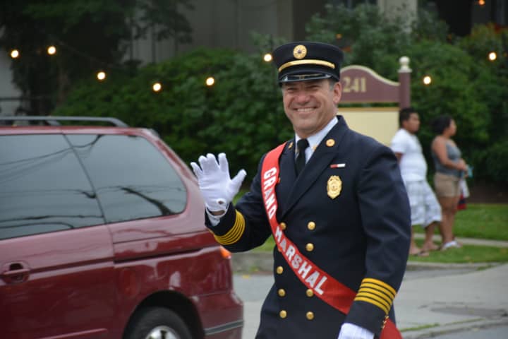 Former Mount Kisco Fire Chief Mario Muccioli marches in the fire department&#x27;s annual parade as grand marshal.