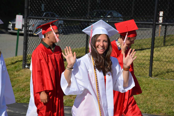 An excited Somers High School 2016 graduate heads to her commencement.