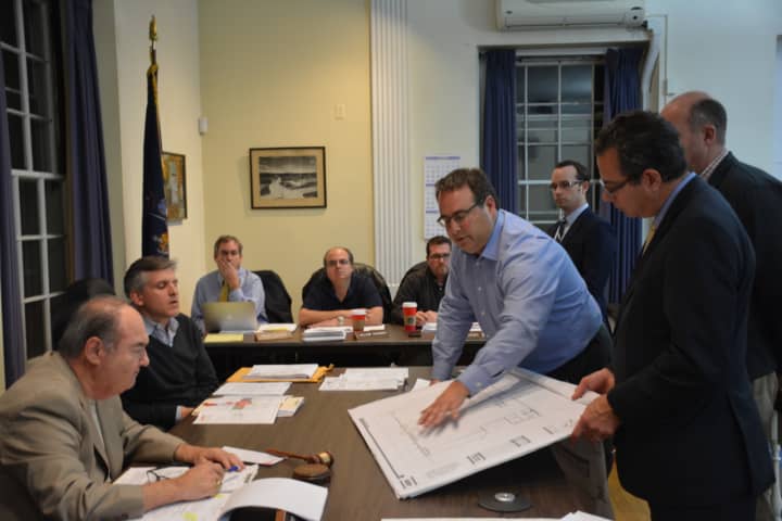 Architect Christopher Raffaelli (center), discusses the revised Modell&#x27;s proposal at a Mount Kisco Planning Board meeting.