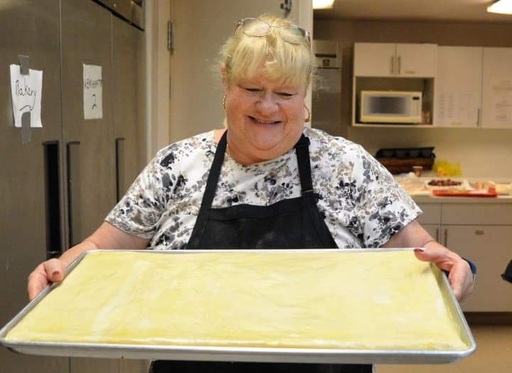 Margaret Klarer of Dumont carrying a tray of baklava ready for the oven.
