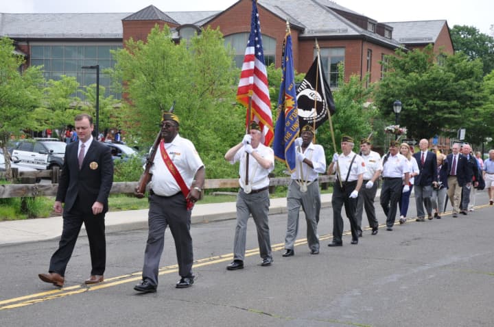 Darien Memorial Day Speaker Brian O&#x27;Malley and Parade Grand Marshal, Len Hunter lead Post 6933 Honor Guard, Selectmen, and townspeople from the Darien Library Community Room to place wreaths honoring veterans at Spring Grove Veterans Memorial statue.