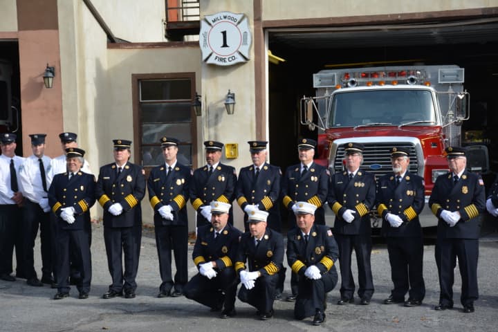Millwood firefighters pose for pictures in front of their old Station No. 1, which is being decommissioned after more than 90 years of service.