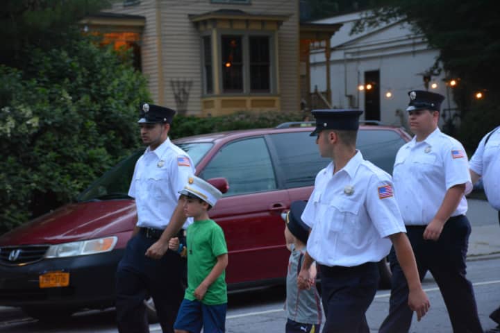 Harrison firefighters, with kids by their sides, marched in the Mount Kisco Fire Department&#x27;s parade in July. Fundraising accounts at the downtown Harrison Fire Department are being examined by the Westchester County District Attorney.