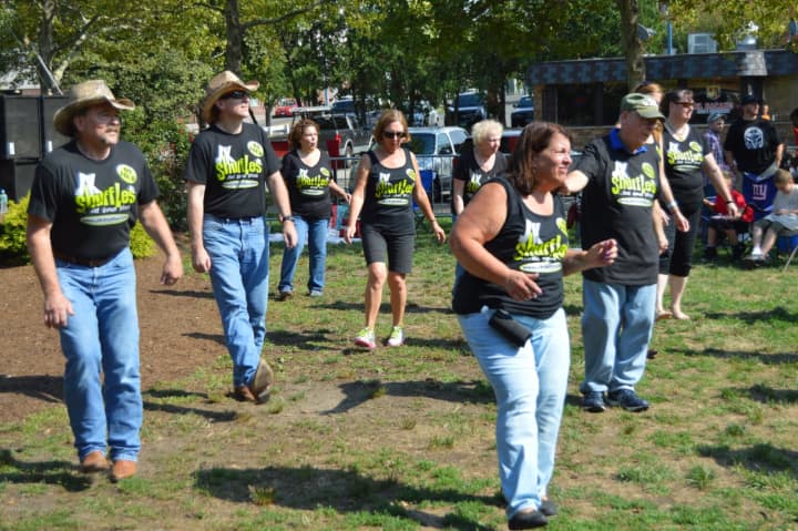 Line dancing is a big part of the scene at the Country Music and Food Truck Rally in Danbury.