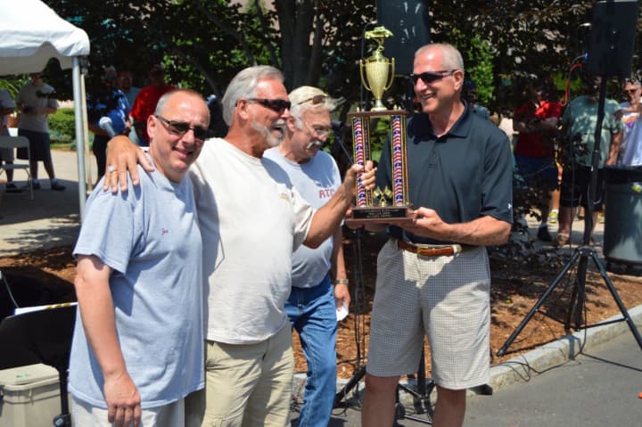 Shelton Mayor Mark Lauretti hands the trophy to Bob Sabre, with his 1958 Chevy Impala, the lucky winner of the Mayor’s Trophy at Sunday&#x27;s classic car show.