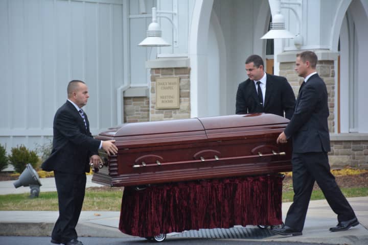 Pallbearers move Frances Ghelarducci&#x27;s casket to a hearse following her funeral at St. Joseph&#x27;s Church in Somers.