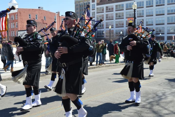 Members of the Fairfield County Police Pipe s&amp; Drums march down Broad Street in Bridgeport.