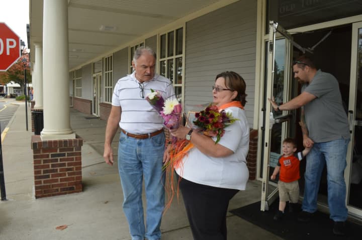 Raeann McLaren, right, presents Zoeli Farkas with two free bouquets, courtesy of City Line Florist in Trumbull.