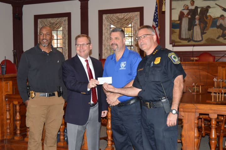 Stratford Mayor John Harkins, second from left, donates $10,000 from his charity golf tournament to Stratford PAL as (left to right) Lt. Curtis Eller, School Resource Officer Alex Voccola and Police Chief Joseph McNeil look on.