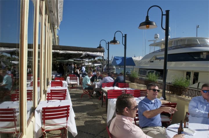 Outdoor dining at L&#x27;Escale Restaurant overlooks Greenwich Harbor.