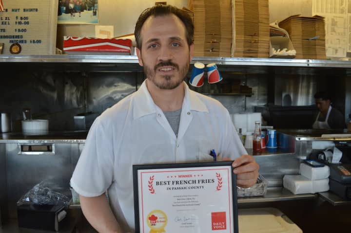 Employee Bill Chrisafinis of Rutt&#x27;s Hut in Clifton accepts Daily Voice&#x27;s DVLicious &quot;Best French Fries in Passaic County&quot; award.