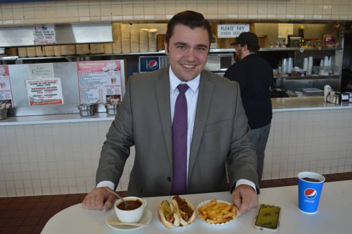 Michael Potoczak of Totowa enjoying two Rutt&#x27;s Hut rippers –with chili and relish – and cheese fries on his lunch break.