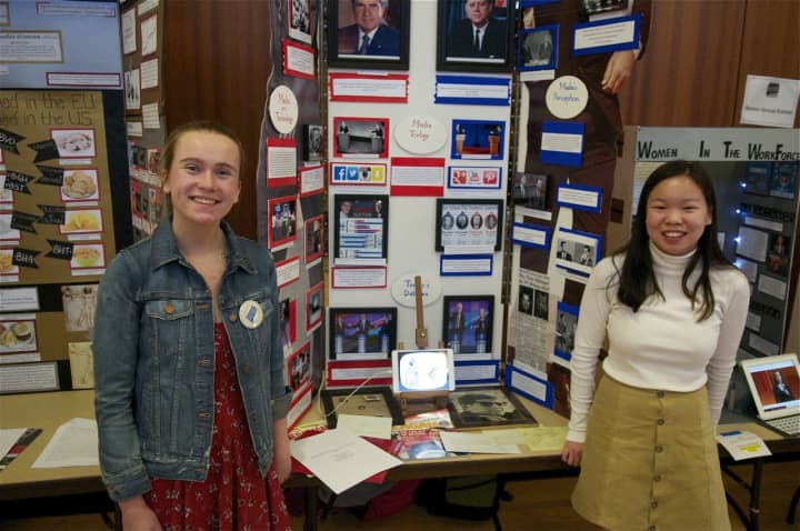 Lizzy Lynch (left) and Kate Williams of Wilton High School with their project &quot;60&#x27;s TV Debates.&quot;