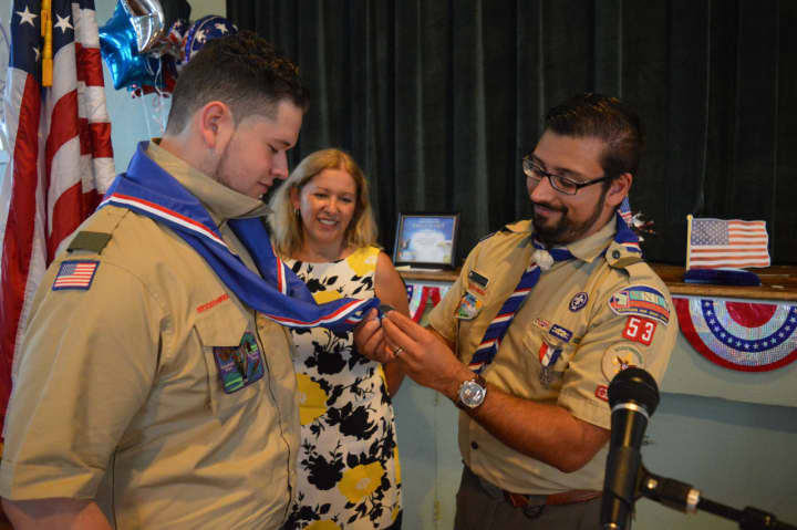 Scoutmaster Peter Marks bestows the Eagle neckerchief upon Jeremy Fine.