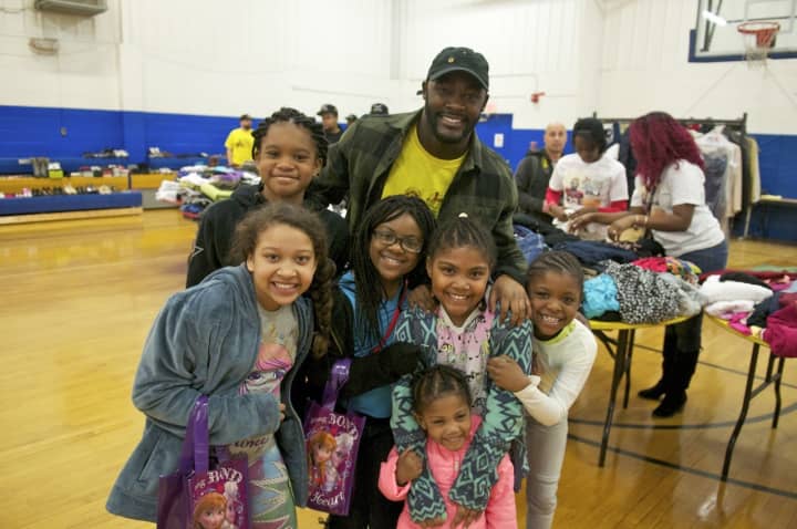 Washington Redskins RB Silas Redd (top) with some of the kids at Saturday&#x27;s Clothing Drive &amp; Swap at the Carver Center in Norwalk.
