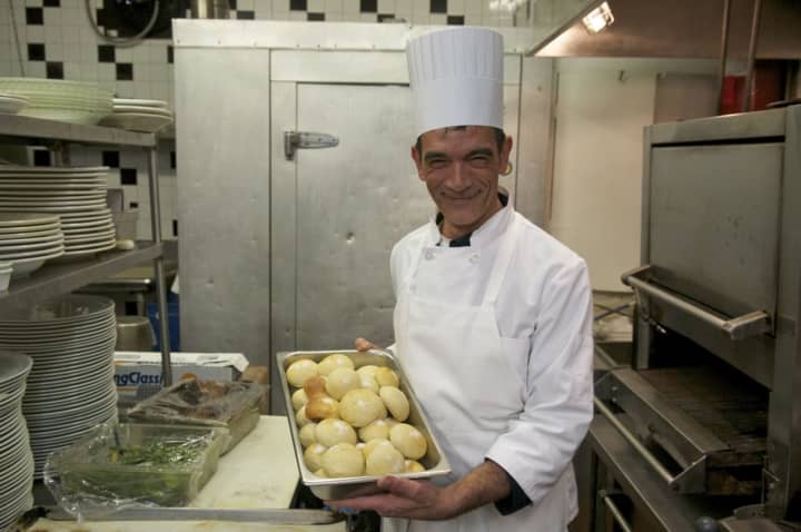 A chef prepares freshly baked rolls at the restaurant.