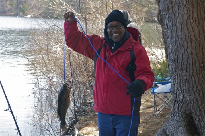 Celebrating the first catch of the day near the Saugatuck Reservoir in Redding, as Fairfield County fishermen come out Sunday for the opening weekend of the trout fishing season.