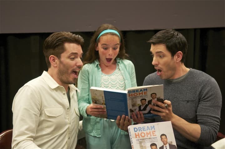 The Property Brothers - Jonathan Scott (L) and Drew Scott - clown around with a fan at Monday&#x27;s book signing.