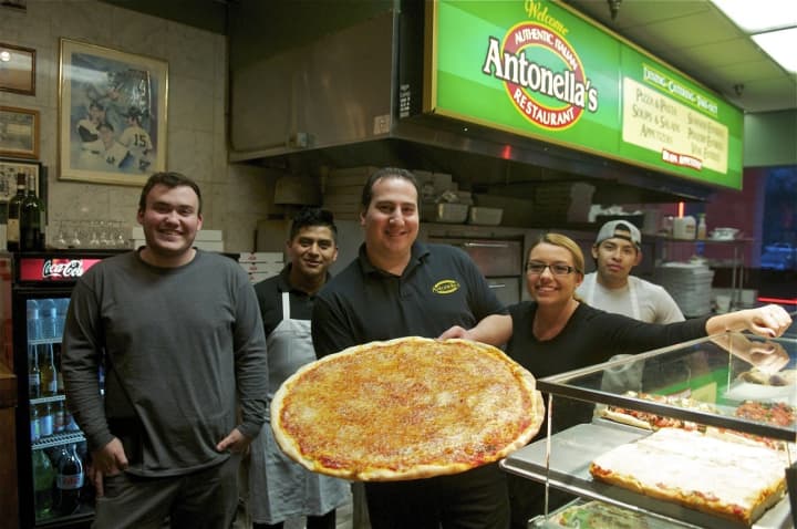 Staff at Antonella&#x27;s with some of their popular pizza.