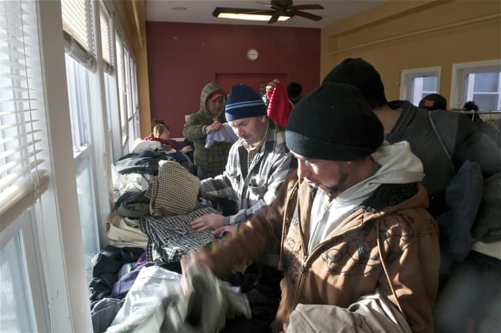 Men look through donated clothing at the Bridgeport Rescue Mission on Thursday.