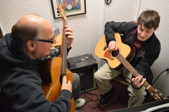 Gus Baxter, left, of Woodside Music Studio in Park Ridge teaching a lesson.