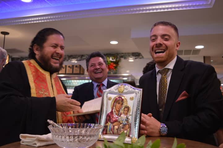 Father Christos L. Pappas of the Ascension Greek Orthodox Church in Fairview blesses the River Edge Diner with owner George Sideras, right, and Mayor Edward Mignone Sunday.