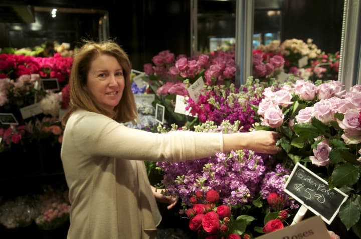 Owner Sandra Nielsen-Baumann works with flowers in the cooler at Nielsen&#x27;s Florist &amp; Garden Shop in Darien.