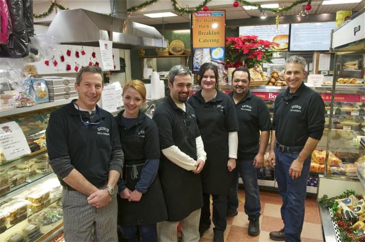 Brothers Lenny and Steve Sauro flank staff at Sauro&#x27;s Gourmet Deli &amp; Catering.