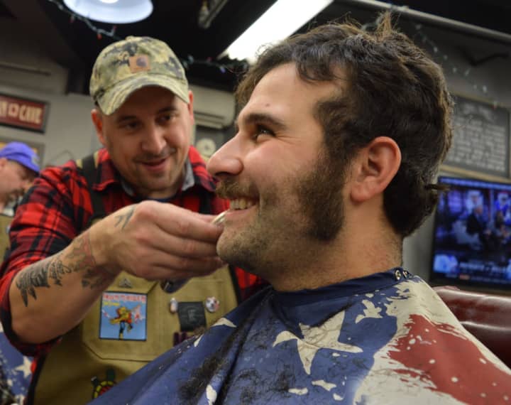 Barber Tom Wright rids Ridgewood Police Officer Christopher Mormino of his facial hair Sunday morning at the Iconic Barber Shop in Glen Rock.