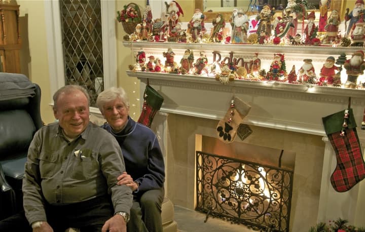 Ed and Lenore Lundberg sit next to their Santa collection - one of many holiday traditions that keeps the holiday spirit flowing.