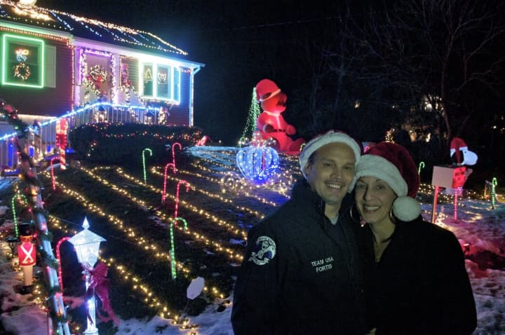 Joe and Dawn Fortis in front of their Fairfax Road display. The couple recently started giving donated funds to a children&#x27;s cancer hospital.