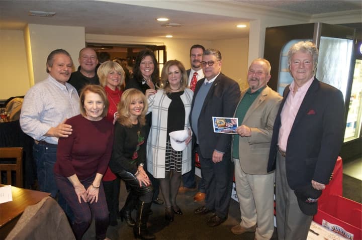Putnam County Executive MaryEllen Odell (center) hosted a holiday party Thursday evening at Putnam County Golf Course, with donations going to United for the Troops, run by Jim Rathschmidt (holding card).