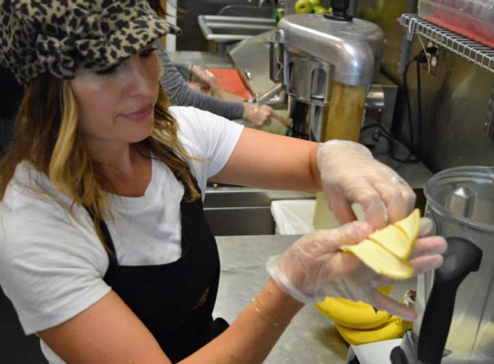 Amy Ratleff making a &quot;DreamSicle&quot; Smovee of Almond Mylk, pineapple, banana, orange, vanilla, Himalayan sea salt, and Herbal Relaxation Blend.