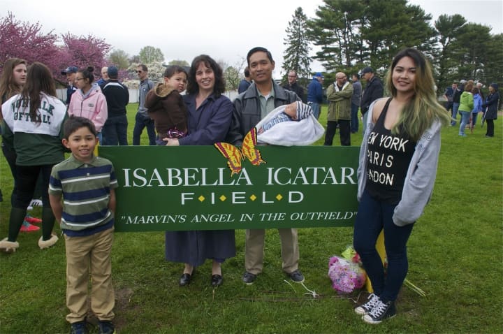 The Icatar family (from left): Nathaniel, 8; Giancarlo, 2; parents Julianne and Roniel; Xavier, 3 months; and Annalise, 16, stand with the sign that bears Isabella&#x27;s name at Saturday&#x27;s dedication ceremony.