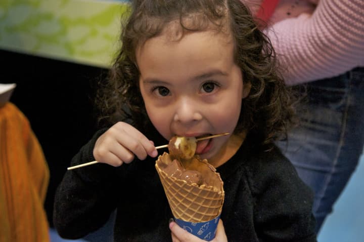 A young girl enjoys a chocolate treat at the Chocolate Expo at the Maritime Aquarium at Norwalk on Sunday.