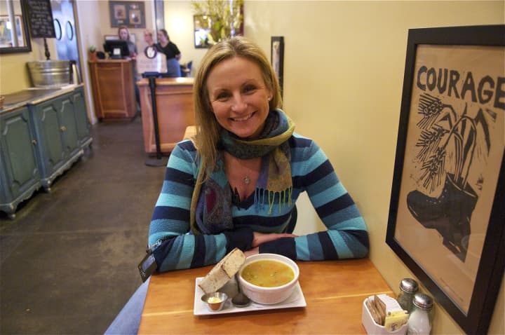 General Manager Melissa Beck with a cup of Thai Red Lentil soup with sourdough miche.
