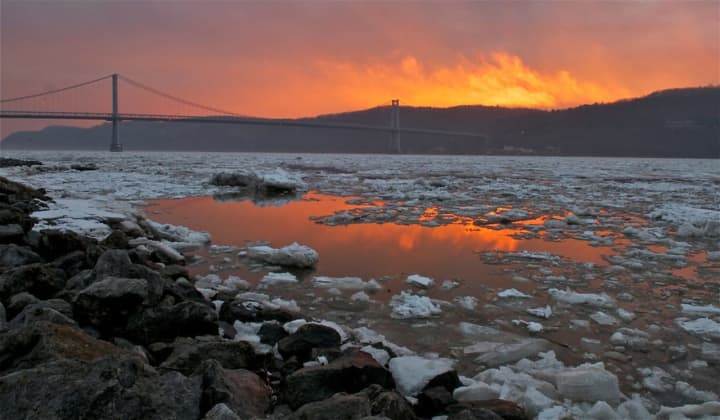 A dramatic sunset reflects off ice flows on the Hudson at the Poughkeepsie waterfront.