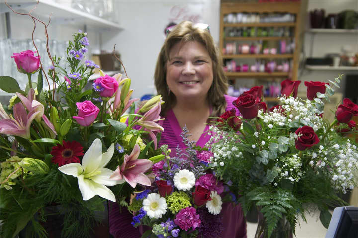 Victoria Morrow of the Village Flower Shop with roses and other Valentine&#x27;s Day arrangements.
