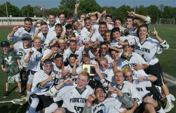 The Yorktown High lacrosse team poses with the Class B championship trophy after Thursday&#x27;s game.