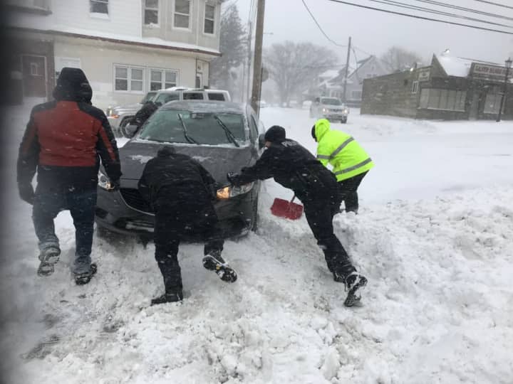 Stratford officers help dig a stranded motorist out of the snow on Thursday