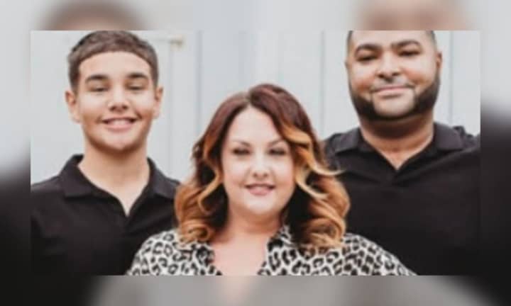 Michelle Hinson (center) pictured with her son (left) and husband (right)