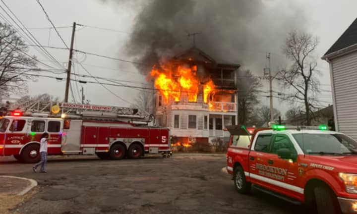 Flames spew from a home in Brockton on Friday morning, Feb. 17