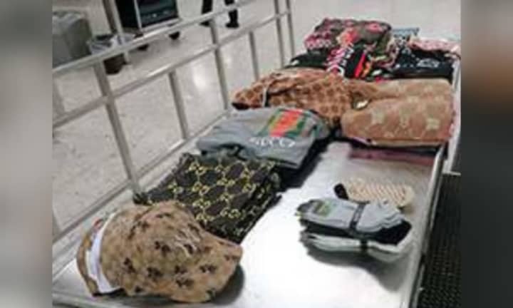 Some of the 298 counterfeit items that CBP officers discovered in a woman&#x27;s baggage.