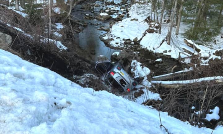 A driver was able to hop out of their car before it rolled down a hill and into a brook in Westhampton on Monday, March 6