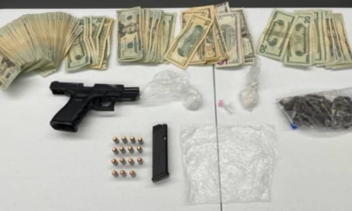 Boston police seized an impressive collection of cash and drugs, as well as a loaded Glock.