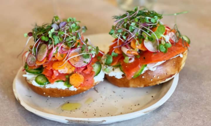 An open-face lox bagel with all the toppings.