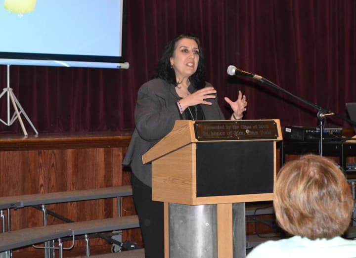 Dover High School Principal Genie Angelis welcomes attendees to the Substance Abuse Forum held at Dover High.