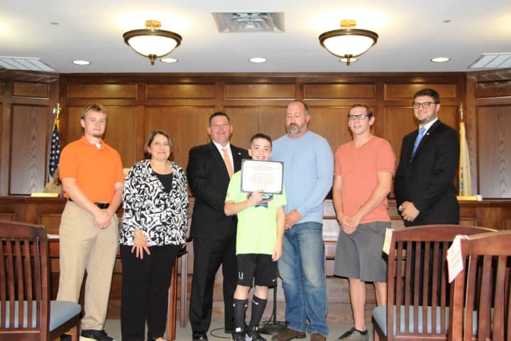 Anthony Dilascio, center, is recognized for his achievements in the track program. Left to right, are coach Tom Hughes, Council person Sonya Buckman, Mayor John DeLorenzo, Robert Brady, Recreation Director, coach Jim Ryan and Councilman Pete Traina.